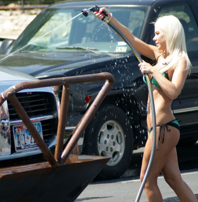 Красивые девушки в купальниках моют автомобили
