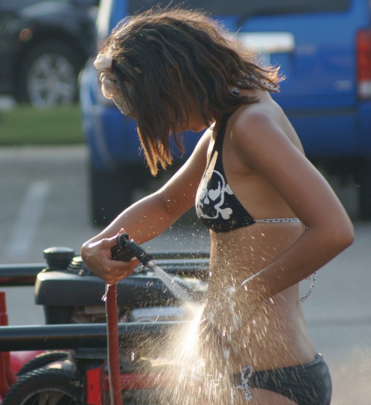 Красивые девушки в купальниках моют машины