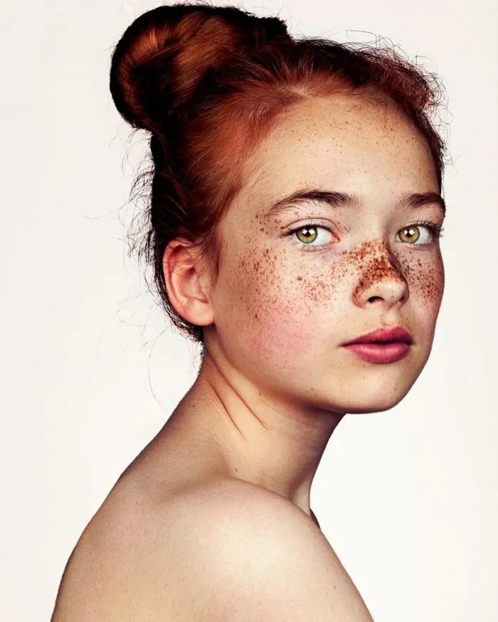 Фотограф делает портреты красивых людей с веснушками